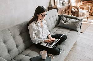 woman writing her CV on a laptop