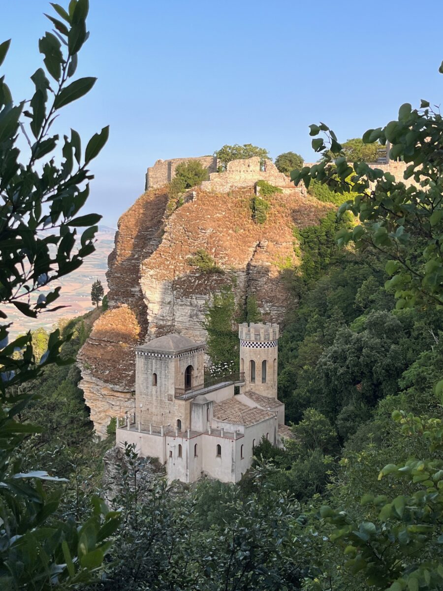 the Castle of Venus in Erice, Sicily seen from in between the trees of the village