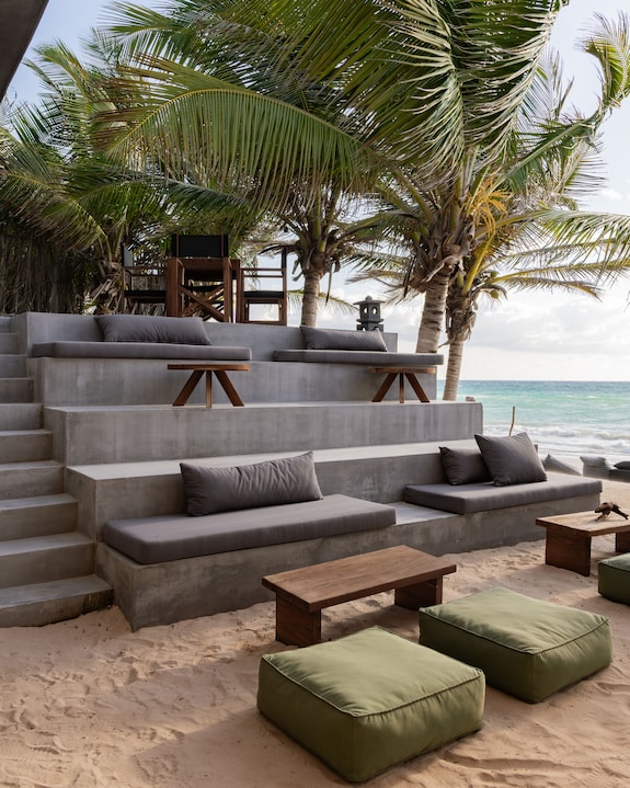 a series of seats on a large staircase on the beach of Tulum