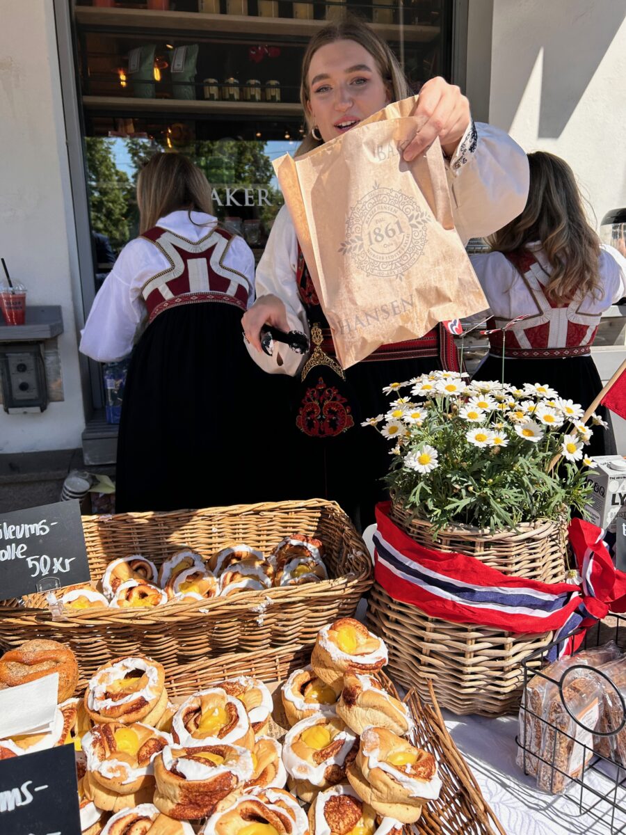 a woman handing fresh baked goods in Oslo, Norway