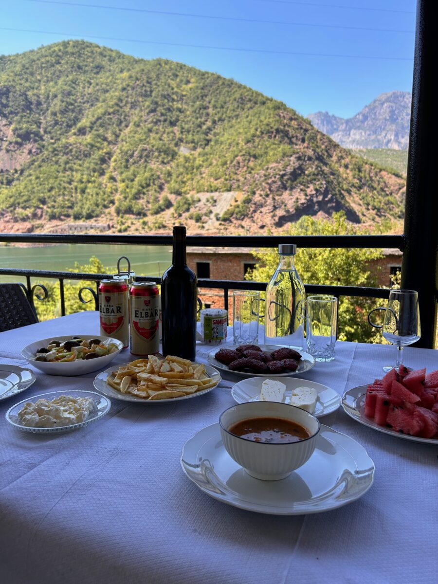 a dinner table with a view of splendid mountains of Albania