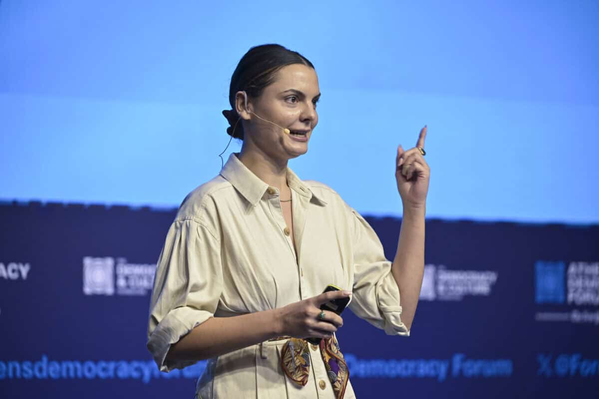 Sophie Vériter speaking on stage at the Athens Democracy Forum