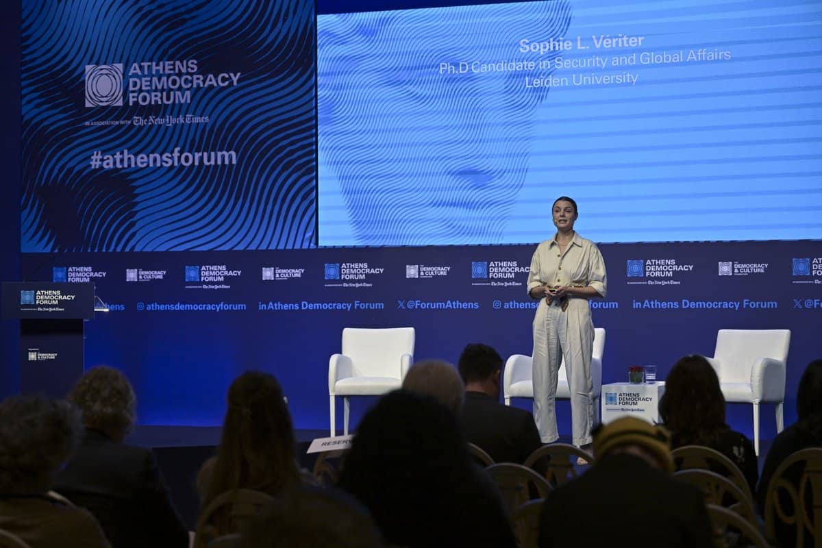 Sophie Vériter speaking on stage at the Athens Democracy Forum