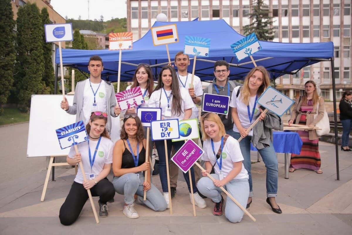 Sophie Vériter, alongside a group of volunteers, holding signs at EU days organised in Gyumri, Armenia in 2017.
