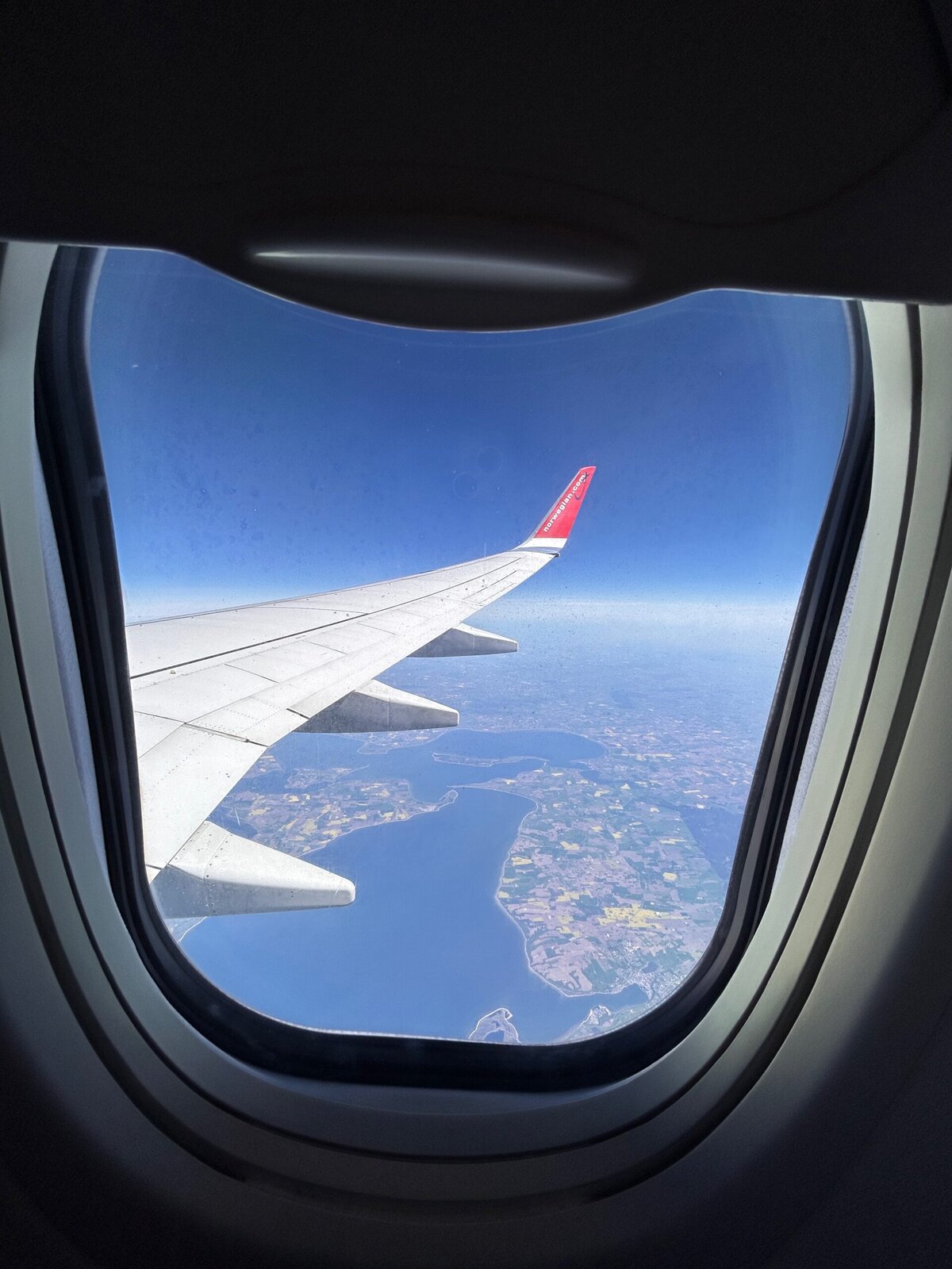 view from a plane window over Norway in the summer