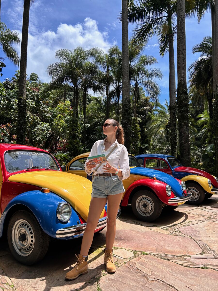 a woman standing in front of art in the open-air museum of Inhotim in Minas Gerais, Brazil.